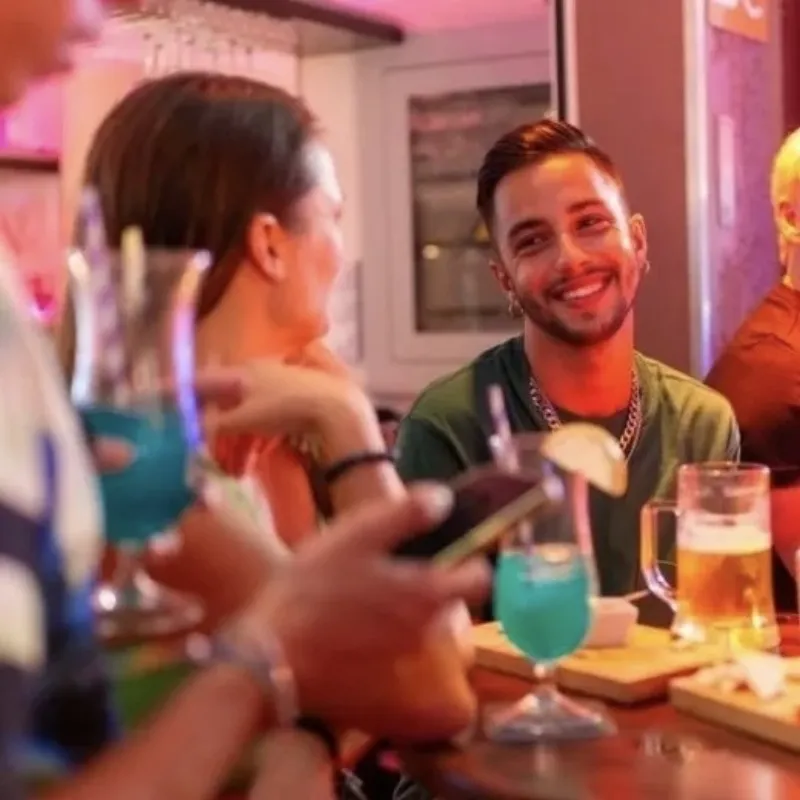 Gay men at a neon-lit land party dancing at Yumbo, Gran Canaria