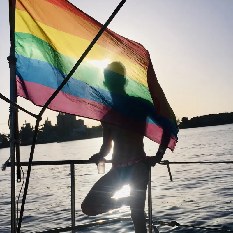 Gay men enjoying a shirtless boat party on a yacht in the ocean